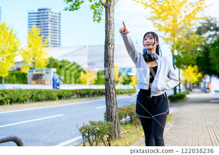 A cool woman walking in a residential area outdoors Training Diet Exercise A cool woman walking in a residential area outdoors Training Diet Exercise 122038236