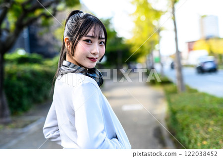 A cool woman walking on a sidewalk in a residential area outdoors, training, diet, exercise, clear A cool woman walking on a sidewalk in a residential area outdoors, training, diet, exercise, clear 122038452