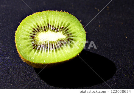 Fresh kiwi cut in half on black background Fresh kiwi cut in half on black background 122038634