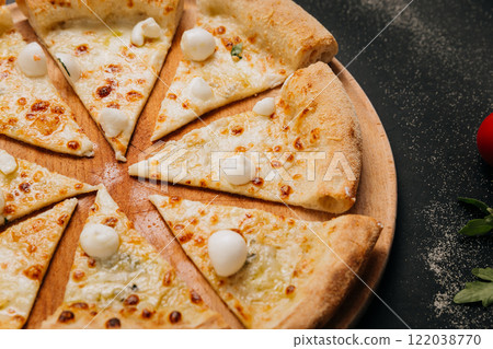 Cheesy pizza slices topped with mini mozzarella, ready to share for the perfect food moment Cheesy pizza slices topped with mini mozzarella, ready to share for the perfect food moment 122038770