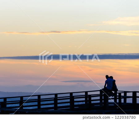 Wedding couple watching the sunset on Carvoeiro beach in Lagoa, Algarve region, Portugal. Romantic 122038780