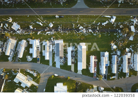 Severely damaged houses after hurricane Ian in Florida mobile home residential area. Consequences of natural disaster Severely damaged houses after hurricane Ian in Florida mobile home residential area. Consequences of natural disaster 122039358