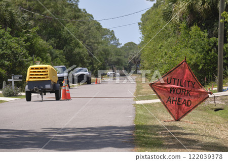 Road work ahead sign on street site as warning to cars about construction and utility works Road work ahead sign on street site as warning to cars about construction and utility works 122039378
