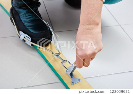 Improved modern cable ski bindings of Kandahar type are mounted on wooden skis. 122039621