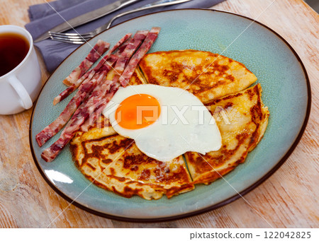 Delicious pancakes with scrambled eggs and bacon 122042825