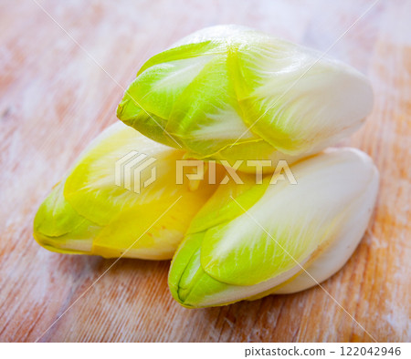 Image of fresh raw endive on the wooden table Image of fresh raw endive on the wooden table 122042946