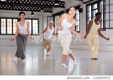 Portrait of smiling young dancing people practicing vigorous swing in studio Portrait of smiling young dancing people practicing vigorous swing in studio 122043053