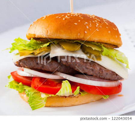 Double cheeseburger with beef, tomato, cheese, cucumber and lettuce Double cheeseburger with beef, tomato, cheese, cucumber and lettuce 122043054