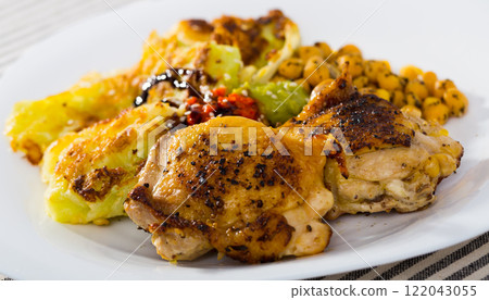 Baked chicken thighs with cabbage in batter, garbanzos, sauces 122043055