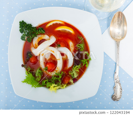 Tomato soup with squid and greens Tomato soup with squid and greens 122043194
