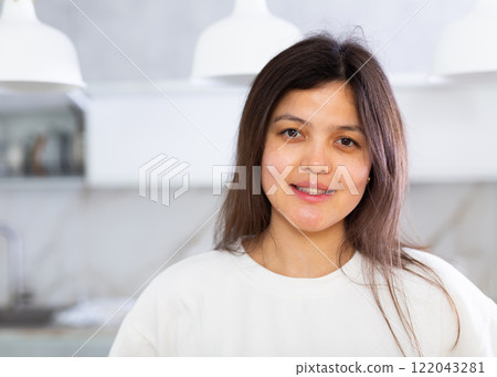 Closeup portrait of pleasant smiling dark-haired young woman Closeup portrait of pleasant smiling dark-haired young woman 122043281