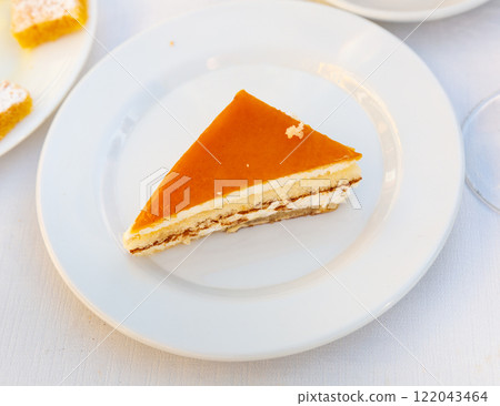 Slice of delicious cheesecake with fruity sauce served in cafeteria 122043464