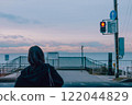 A woman waiting at a red light 122044829