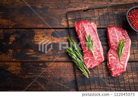 Raw Top blade steak, marbled black angus prime beef. wooden background. top view 122045073