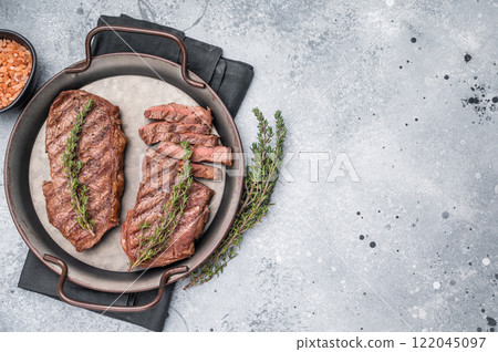 Roast Top blade steak, grilled beef shoulder meat. grey background. top view 122045097