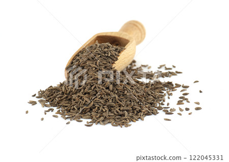 Wooden scoop pouring caraway seeds on white background 122045331