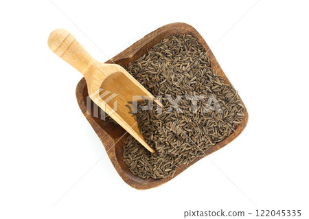 Caraway seeds in wooden bowl with scoop on white background 122045335