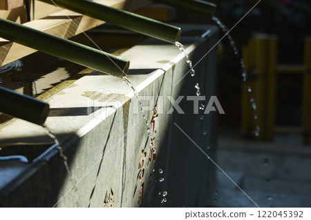 A shrine's water basin bathed in sunlight 122045392