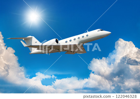 White modern luxury private jet flies in the air above the clouds 122046328
