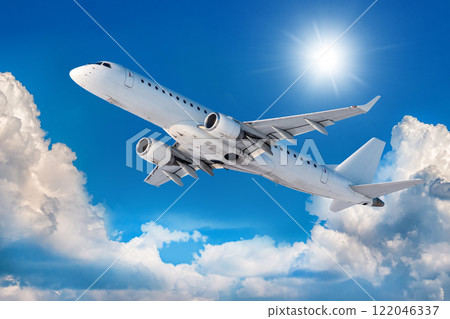 White passenger aircraft is climbing in the air above scenic clouds 122046337