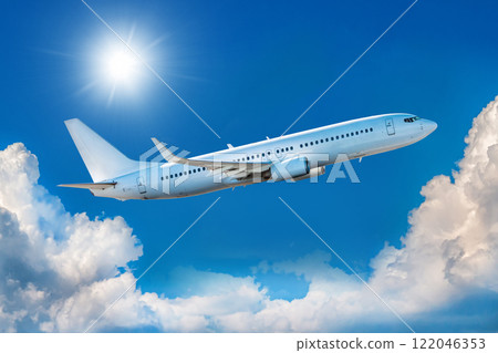 White passenger airliner takes off in the blue sky 122046353