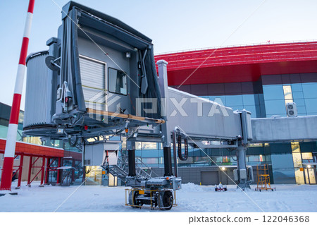 Empty passenger air bridge at winter airport apron 122046368