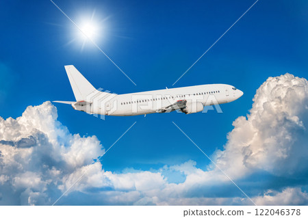 White passenger jet plane fly in the air above picturesque clouds White passenger jet plane fly in the air above picturesque clouds 122046378