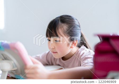 Girl studying on a tablet Girl studying on a tablet 122046909