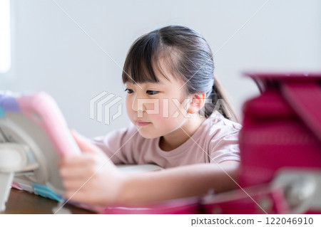 Girl studying on a tablet Girl studying on a tablet 122046910