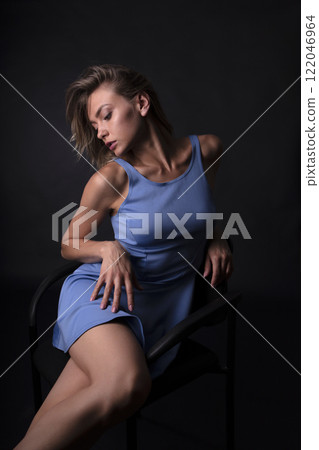 portrait of a young beautiful woman on a dark background 122046964