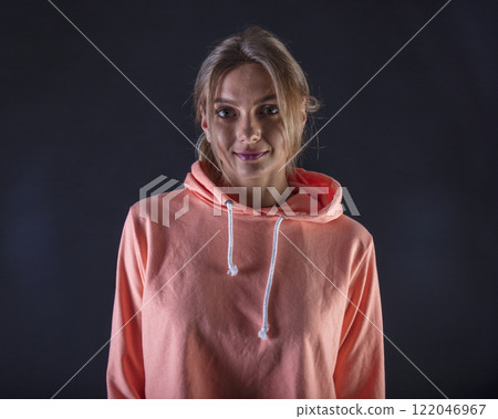 portrait of a young beautiful woman on a dark background 122046967