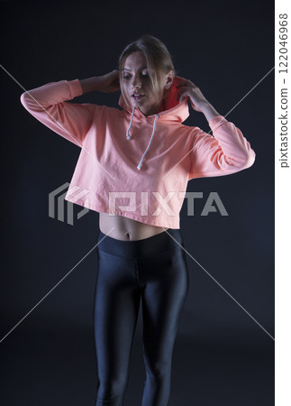 portrait of a young beautiful woman on a dark background 122046968