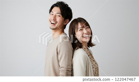 Couple of men and women standing back to back, matching 122047467