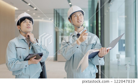 A man in work clothes having a meeting A man in work clothes having a meeting 122047819