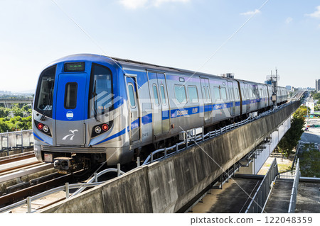 View of a Taoyuan International Airport line train running on the elevated track of the Taoyuan Mass Rapid Transit System. View of a Taoyuan International Airport line train running on the elevated track of the Taoyuan Mass Rapid Transit System. 122048359