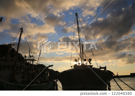 A beautiful sunset over the island at Nishina Port 122048380