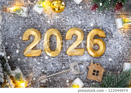 New Year 2026 golden numbers and House key with tiny form of home on festive grey wooden background flatlay, lights of garlands, greeting card. Housing, real estate, relocation, mortgage, insurance New Year 2026 golden numbers and House key with tiny form of home on festive grey wooden background flatlay, lights of garlands, greeting card. Housing, real estate, relocation, mortgage, insurance 122049974