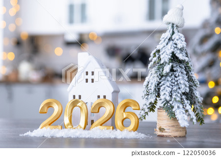 Golden number 2026 and tiny home on background of cozy white kitchen with Christmas tree and Christmas decor with garland lights. Housing, interior, renovation, mortgage, rent in New Year Golden number 2026 and tiny home on background of cozy white kitchen with Christmas tree and Christmas decor with garland lights. Housing, interior, renovation, mortgage, rent in New Year 122050036