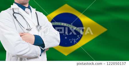 Brazilian Health and Care concept. Professional doctor on Brazilian flag. Doctor with crossed arms on Brazilian flag 122050137