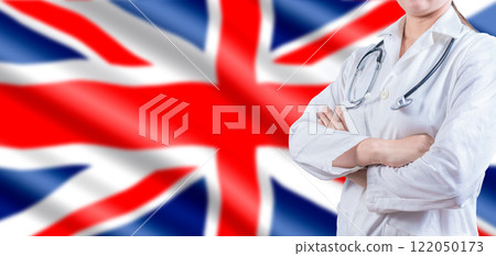 Doctor with crossed arms on UK flag. UK Health and Care concept. Female doctor on UK flag Doctor with crossed arms on UK flag. UK Health and Care concept. Female doctor on UK flag 122050173