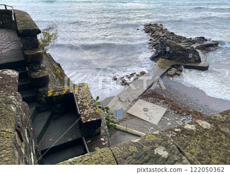 Old stone path near sea in fall. Overcast weather, fog. Old construction in Italy. Municipality Moneglia, Liguria region. View from mountain. Old stone path near sea in fall. Overcast weather, fog. Old construction in Italy. Municipality Moneglia, Liguria region. View from mountain. 122050362