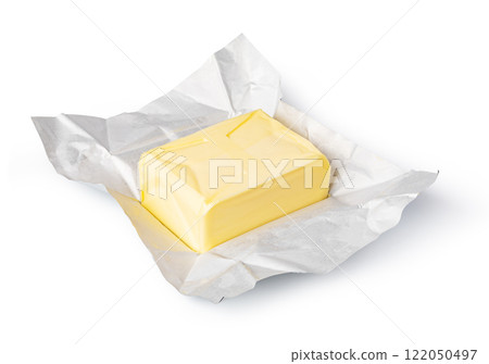 Wrapped butter block on white background: dairy product photography 122050497