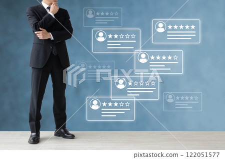 A businessman looking at customer reviews and planning a business strategy 122051577