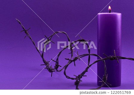 Holocaust memorial day. Candle and Barbed Wire 122051769