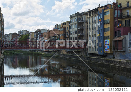 Spain, Gerona - 18 September, 2017: the Pedestrian bridge by the French engineer Eiffel over the river Onyar Spain, Gerona - 18 September, 2017: the Pedestrian bridge by the French engineer Eiffel over the river Onyar 122052111