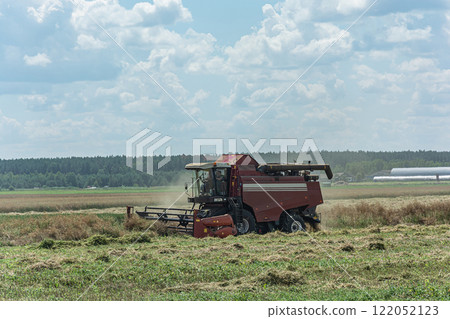 Gomel, Belarus - 07/12/2018: combine harvester in the field harvests grain Gomel, Belarus - 07/12/2018: combine harvester in the field harvests grain 122052123
