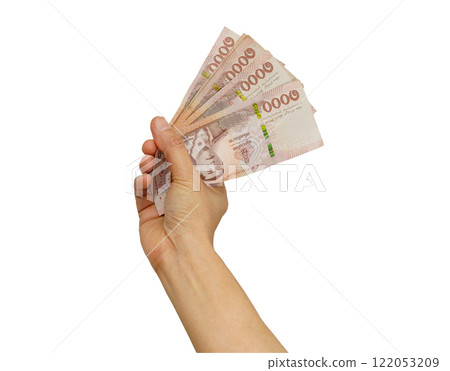 Asian woman counting Thai baht banknote money and holding in hand isolated on white background. 122053209