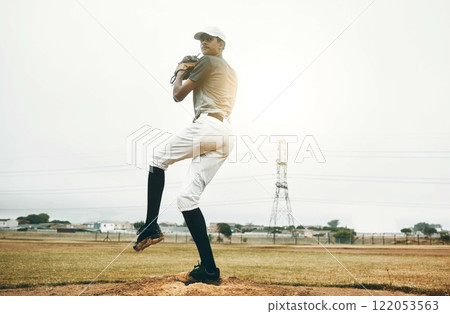 Baseball player, pitch and sports athlete man outdoor on a field with focus and fitness. Game training, exercise and team workout of a strong person playing baseball ready for cardio and exercising 122053563