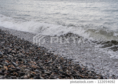 Sea waves on the pebbles shore Sea waves on the pebbles shore 122054092