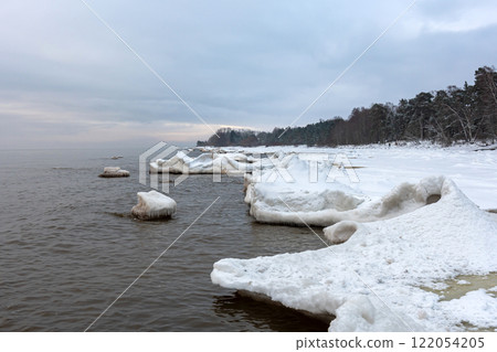 Seascape depicting landscape of Baltic sea and beach with ice and snow formations 122054205